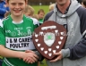 North Antrim PRO Ciaran Hasson presenting Conn Magees Glenravel team captain Thomas O'Kane with the North Antrim U12B Go Games Shield