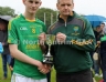 North Antrim GAA Chairmain Owen Elliott presenting McMullan Cup Final Captain Aaron Crawford with the McMullan Cup Final Trophy