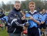 North Antrim GAA Chairmain Owen Elliott presentring St McNissi captain Ciaran McGill with the North Antrim U14 Feile B Trophy