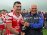 Niall Wheeler of Feis na nGleann committee presents the Man of the Match award to Barney McAuley