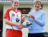 Antrim Camogie Chairperson Julia McMullan presenting Loughgiel Shamrocks captain Emma McFadden with the Senior Feis Camogie Trophy